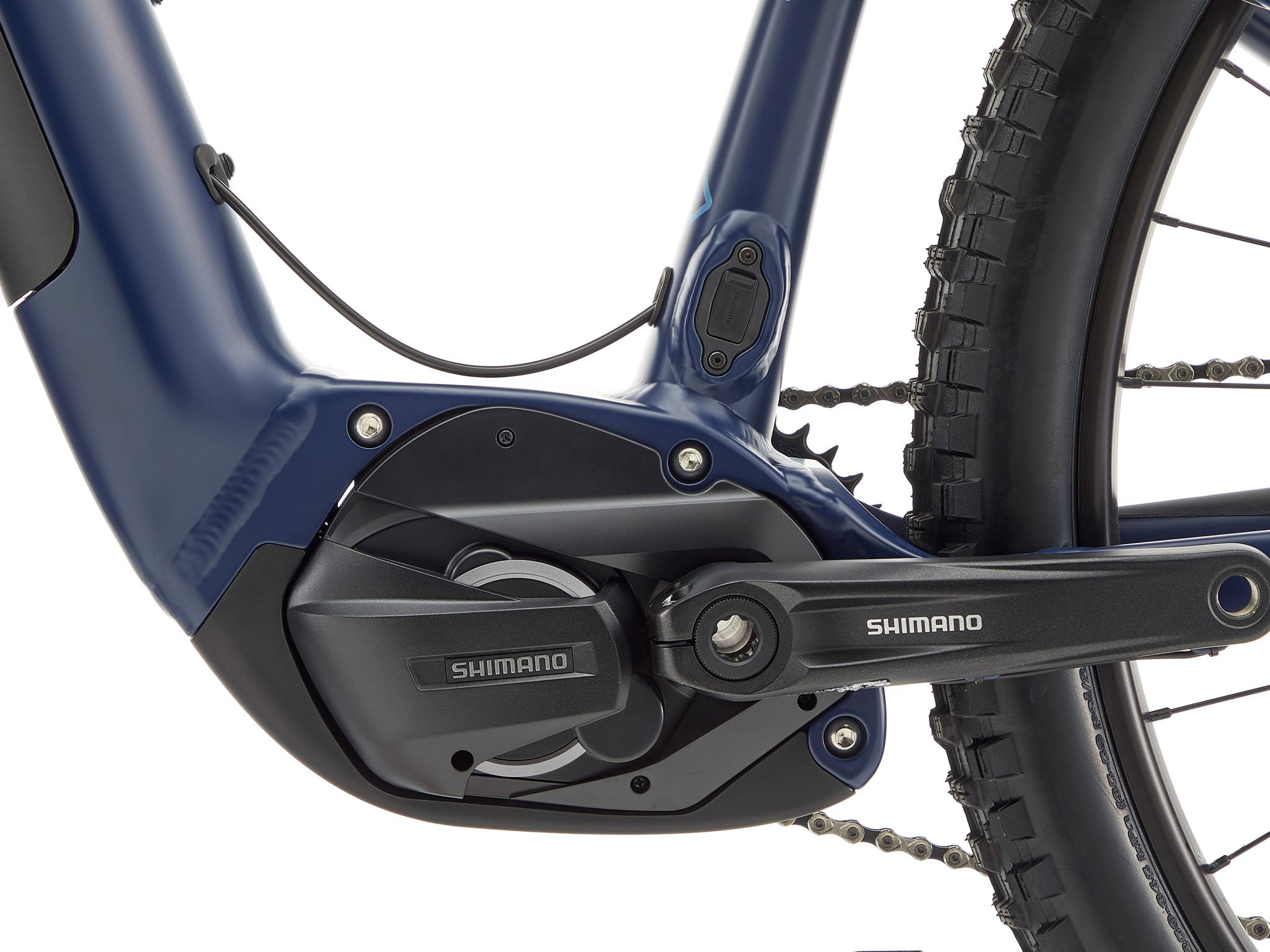 Side view of Kona Remote TrailMaster 140 e-MTB parked on a forest trail, showcasing its rugged frame and Shimano motor.