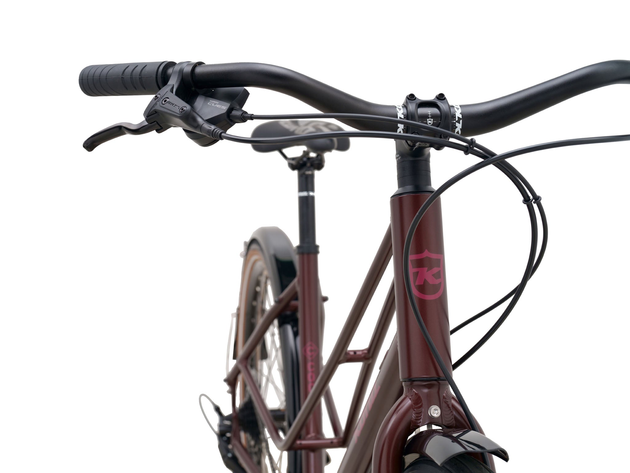 Coco Cruiser step-through bike parked in a sunny urban setting, showcasing its sleek design.