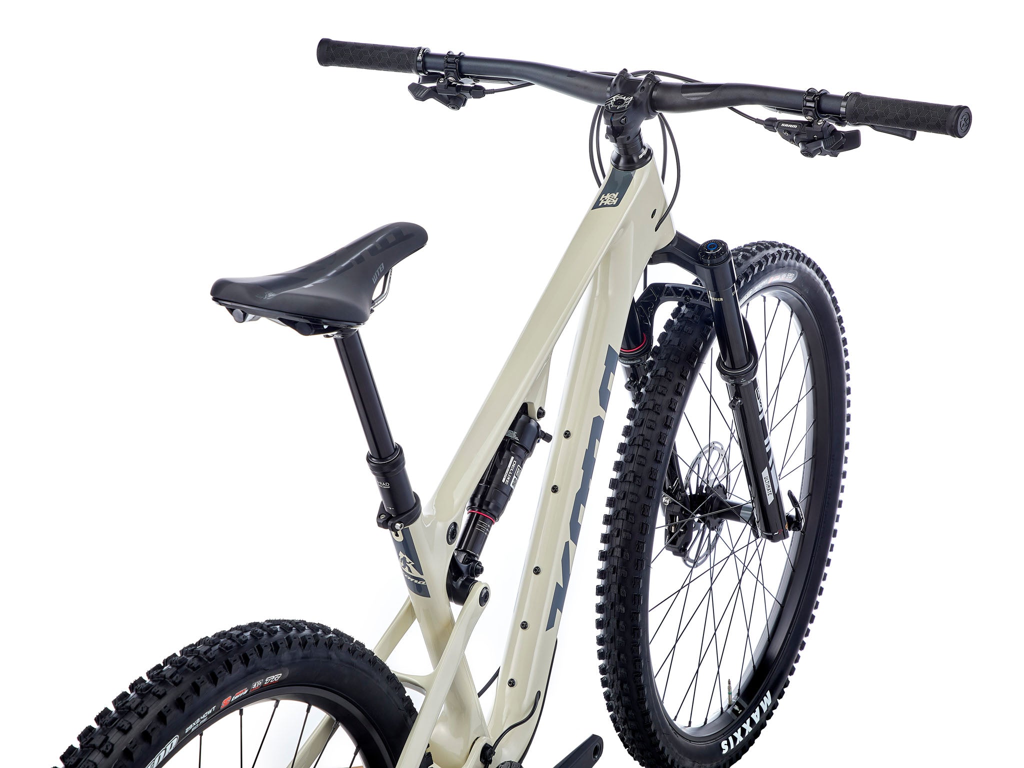 Side view of the Kona Hei Hei CR carbon mountain bike perched on a rocky ridge at sunrise, highlighting the sculpted carbon frame and 29-inch wheels ready for climbing.