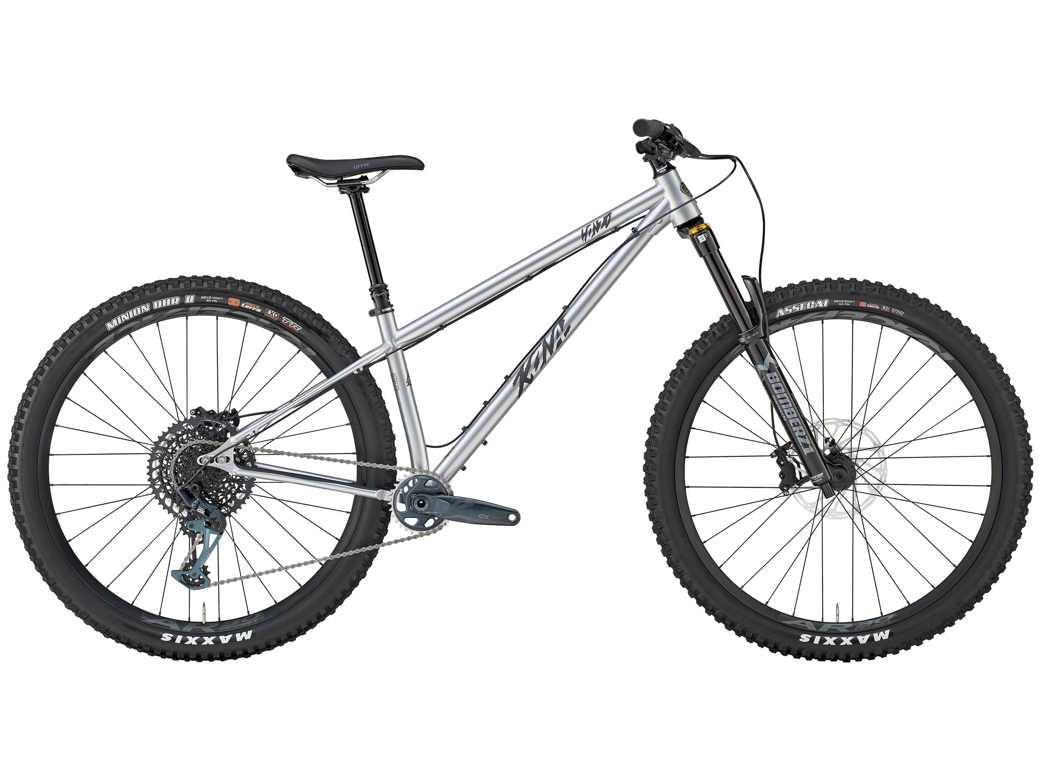 Kona Honzo ESD steel hardtail ripping down a root-laced trail, 150 mm fork fully compressed and rider pinned