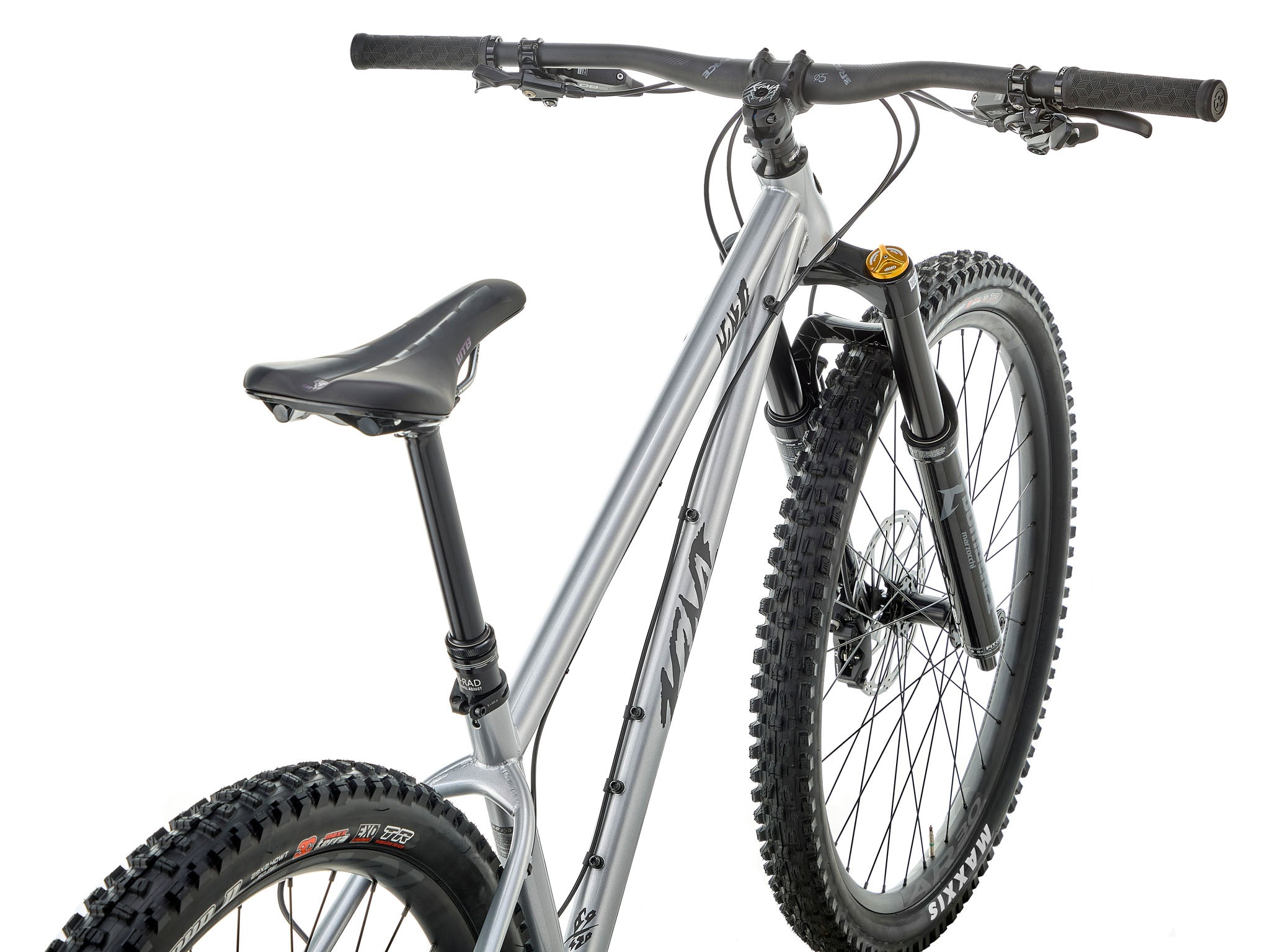 Kona Honzo ESD steel hardtail ripping down a root-laced trail, 150 mm fork fully compressed and rider pinned