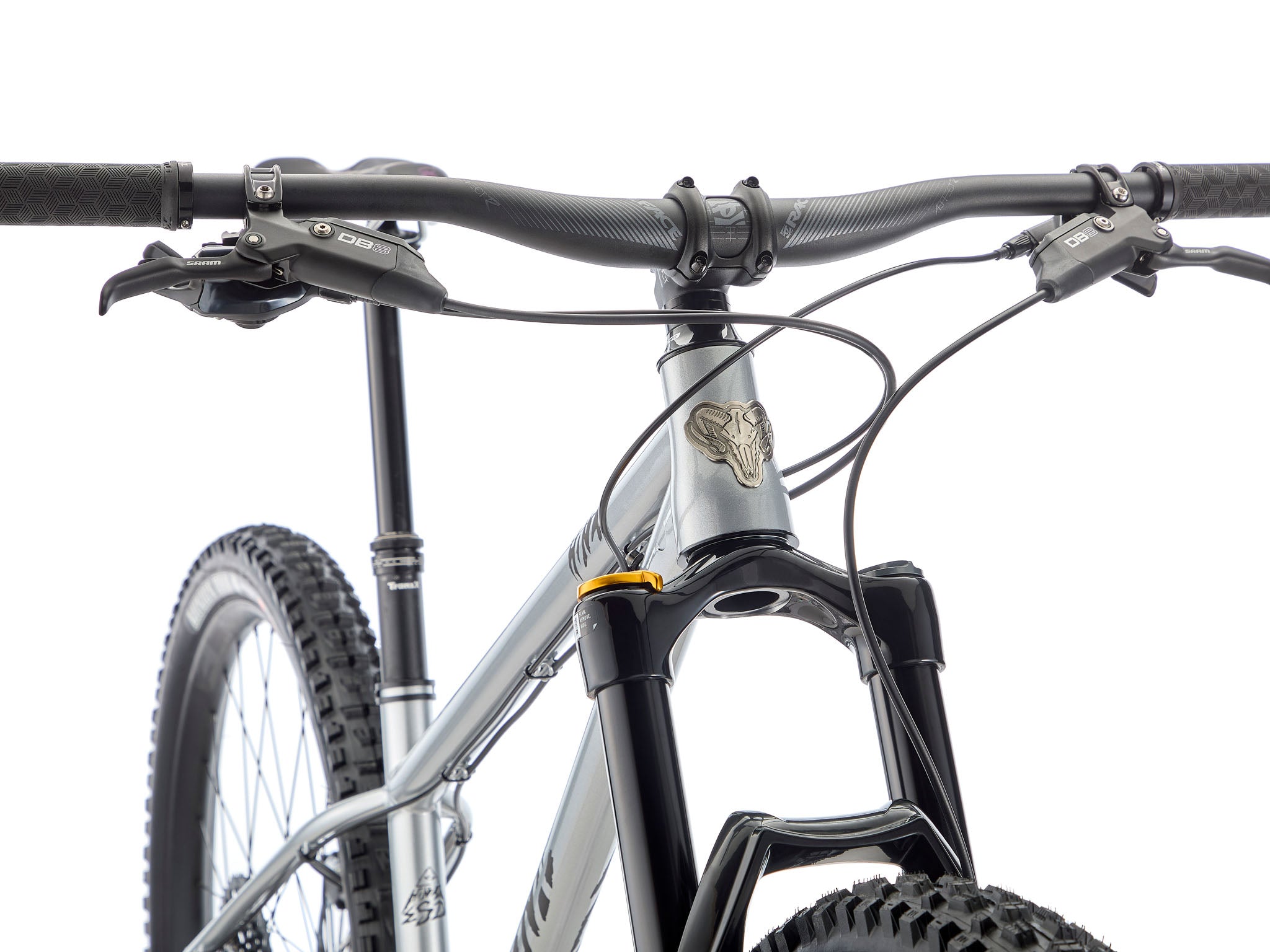 Close-up of the cromoly frame’s gusseted head tube and 4-piston brake caliper clamping a 203 mm rotor