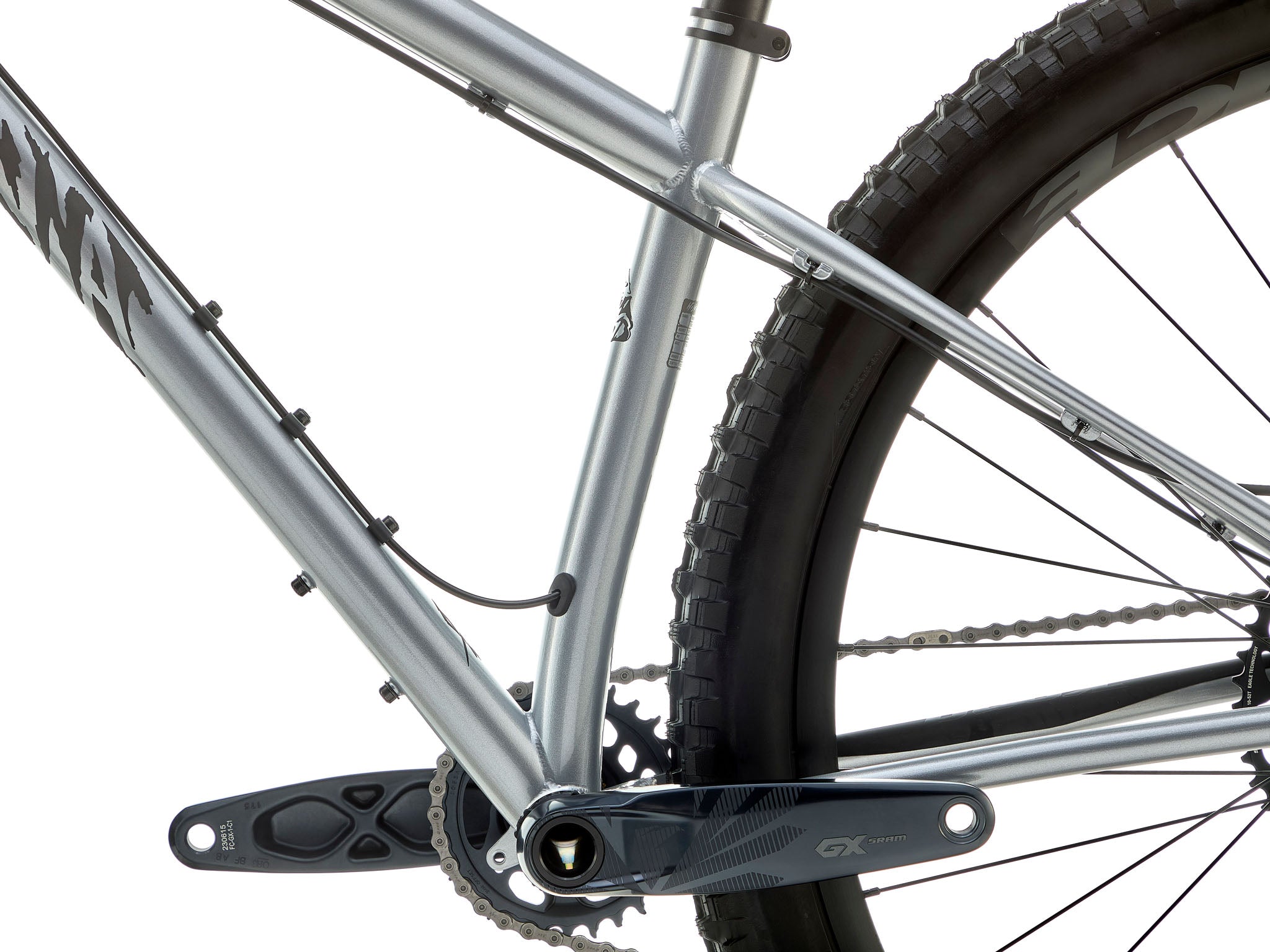 Close-up of the cromoly frame’s gusseted head tube and 4-piston brake caliper clamping a 203 mm rotor