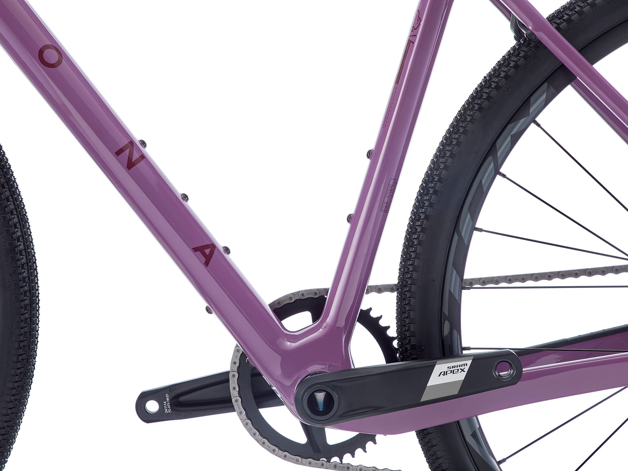 Side view of drop bar bike showcasing wide tire clearance and carbon frame design