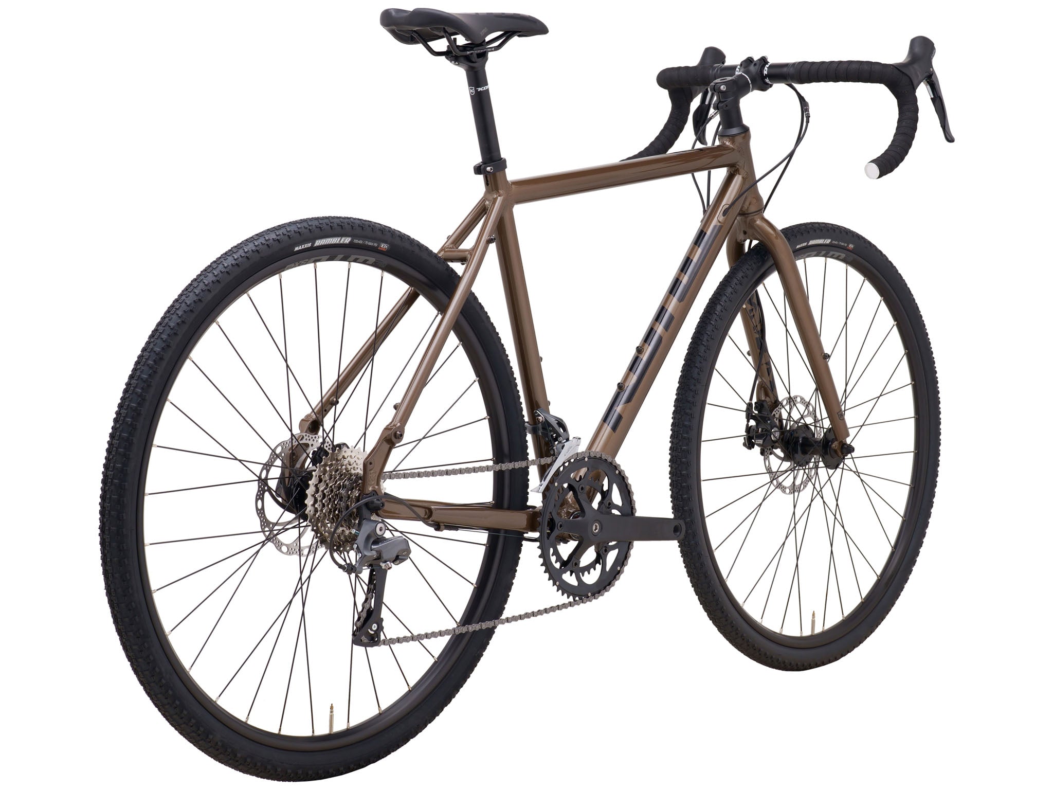 Gravel bike leaned against a café wall during a relaxed weekend trip