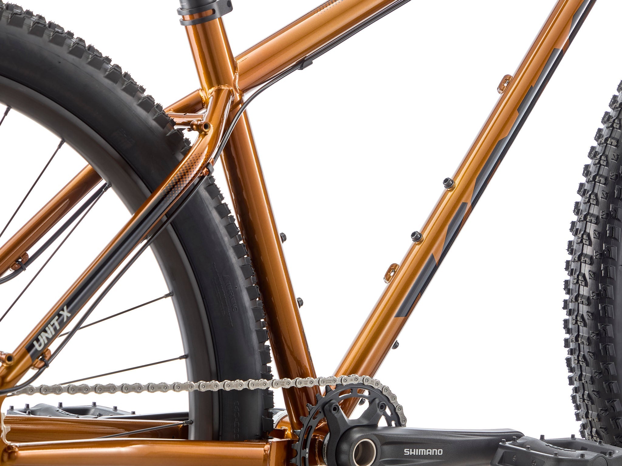 Side view of Kona Unit X bike on mountain trail, perfect for bikepacking adventures