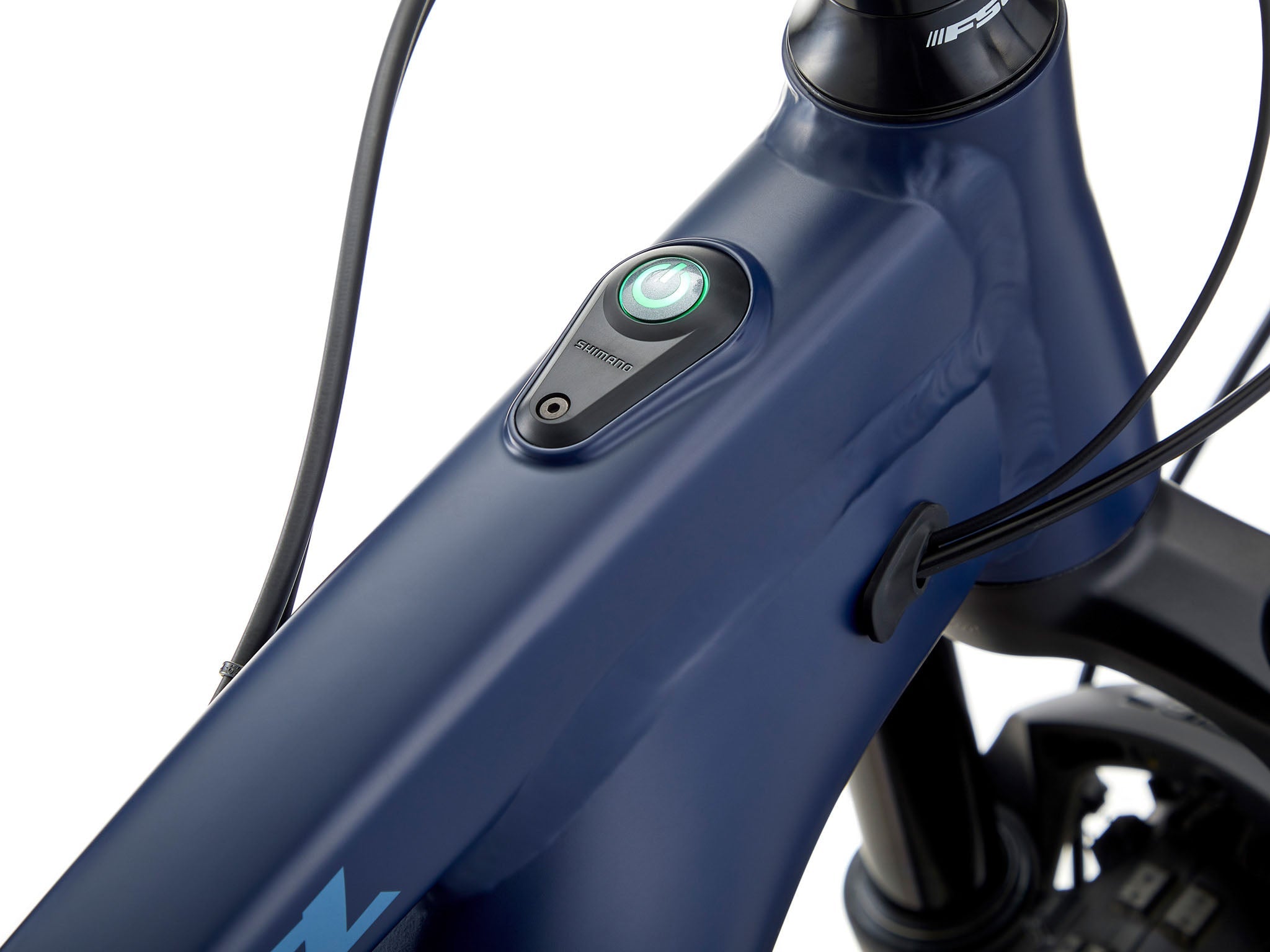Side view of Kona Remote TrailMaster 140 e-MTB parked on a forest trail, showcasing its rugged frame and Shimano motor.