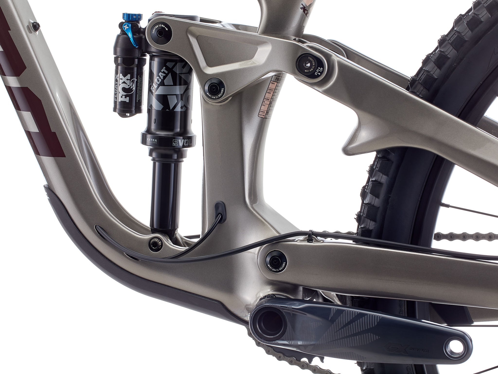 Close-up of the 170 mm rear linkage and alloy rocker arm under golden-hour light