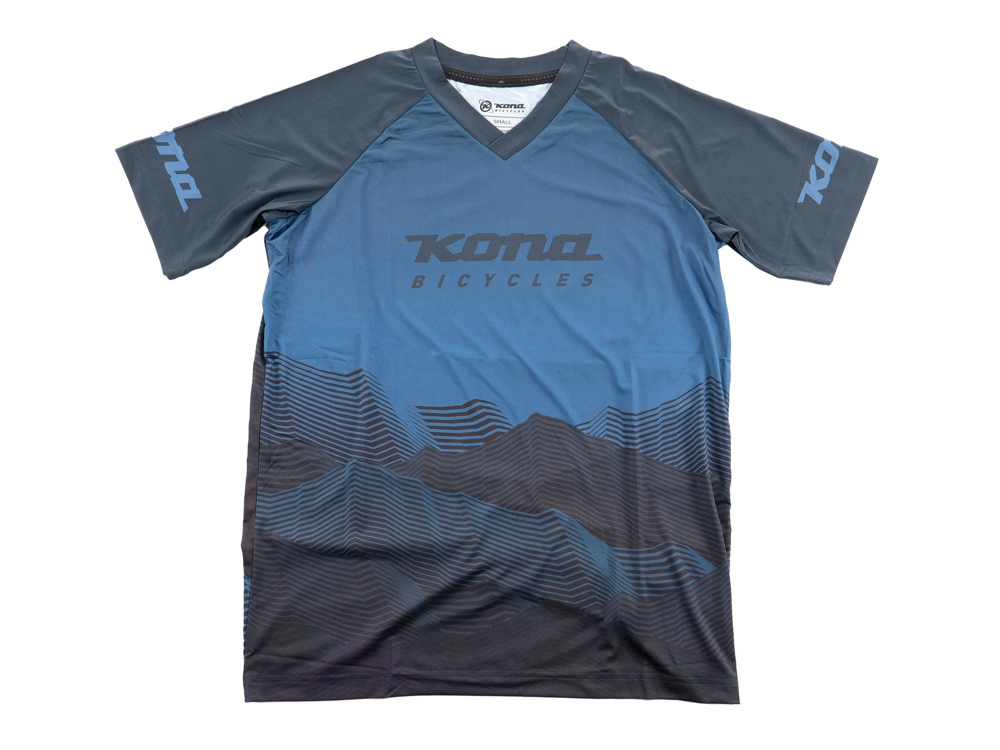 Front view of versatile unisex mountain cycling jersey worn by a cyclist on a trail.
