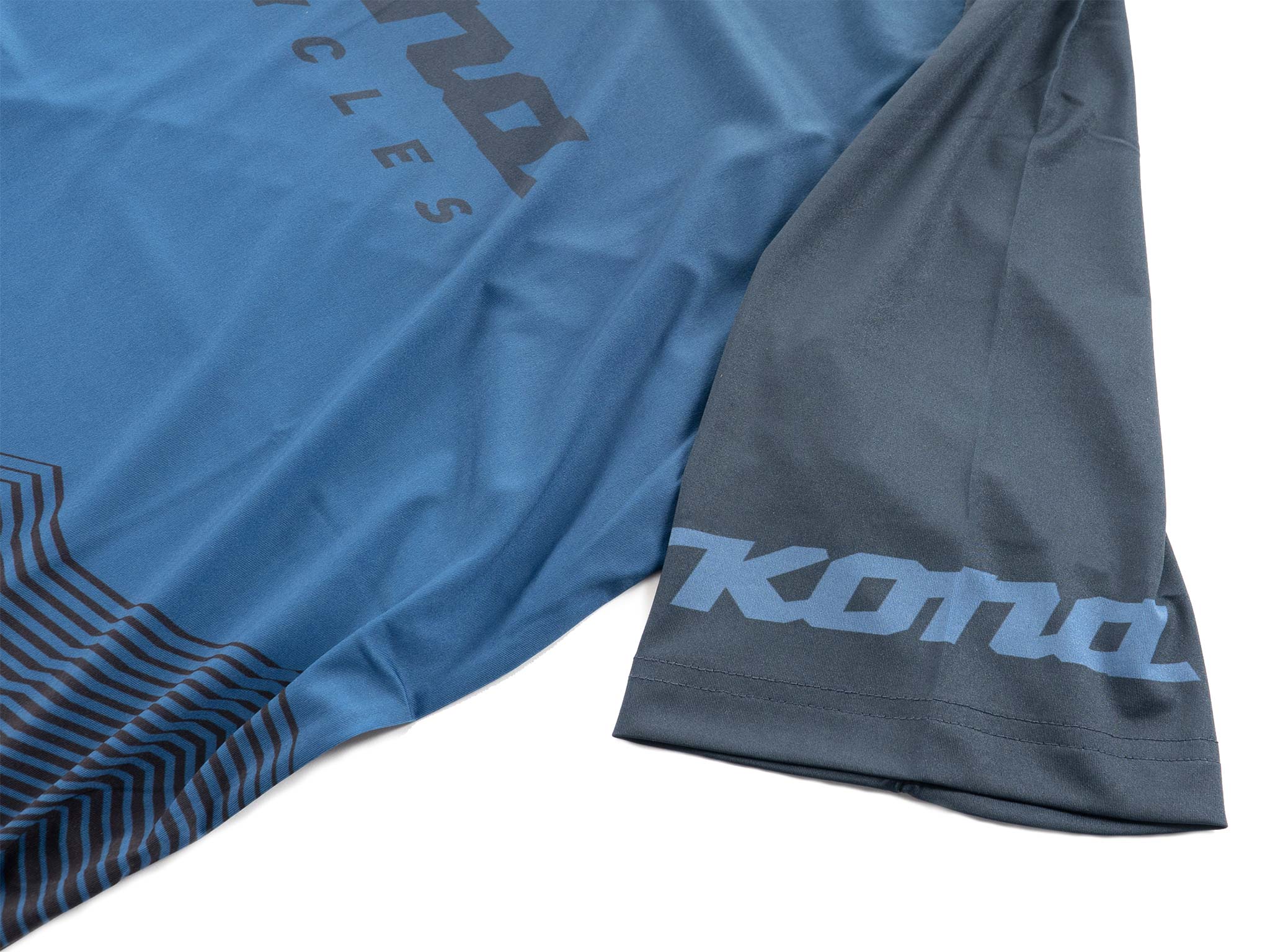 Front view of versatile unisex mountain cycling jersey worn by a cyclist on a trail.