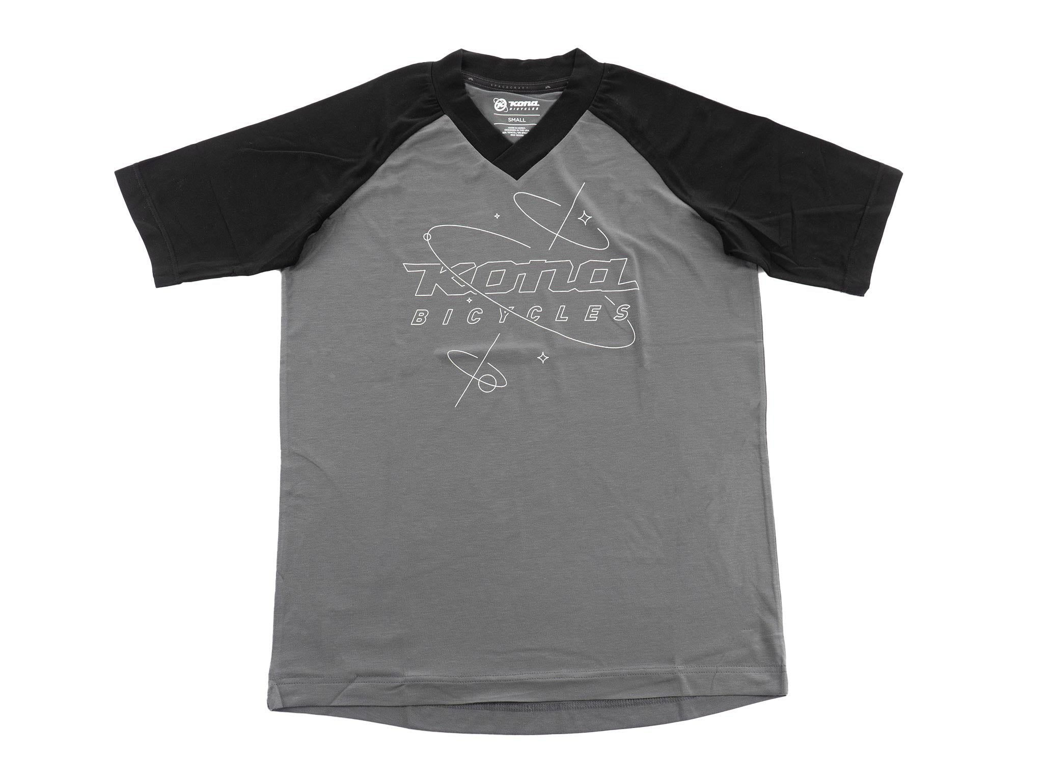 Front view of Orrery RideTech unisex biking shirt draped over handlebars at golden hour
