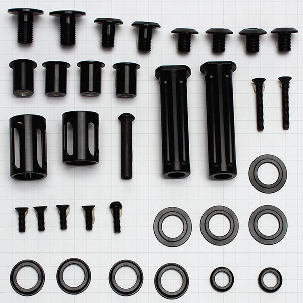 Top-down shot of TrailTune G2 rebuild kit showing stainless bike bolts laid out with pivot hardware