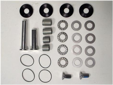 Overhead shot of CMPMLKBK01 needle-bearing bushing kit spread out on workbench with coilair linkage parts labeled
