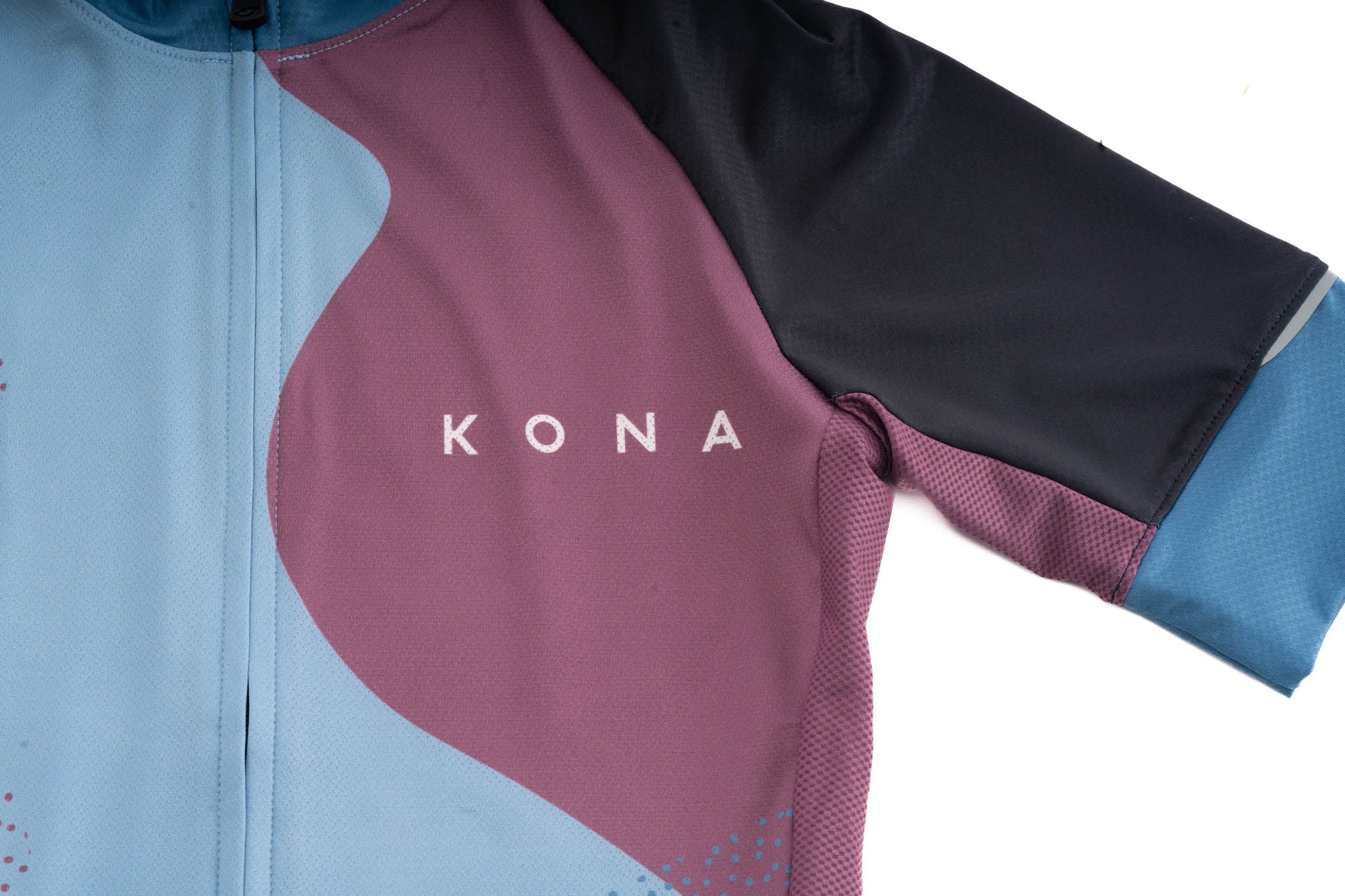 Close-up of reflective details and UPF fabric on cycling jersey