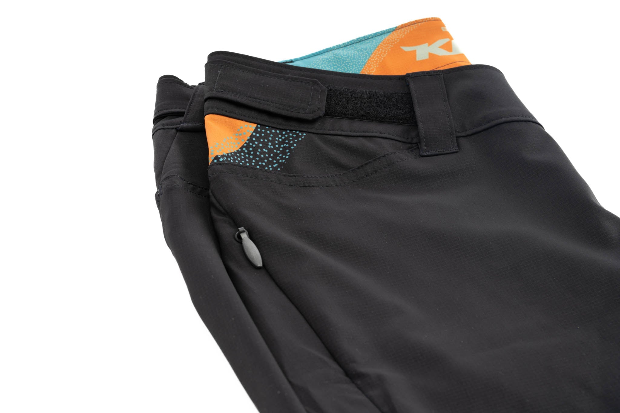 Side view of lightweight womens athletic shorts showing the relaxed fit and waist adjustment tabs.