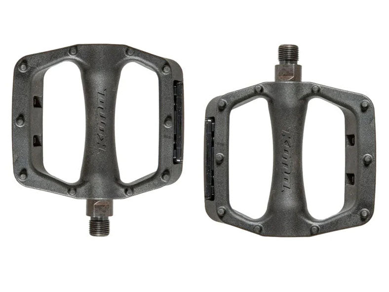 Jackshit II composite platform pedals mounted on a mountain bike in rugged terrain