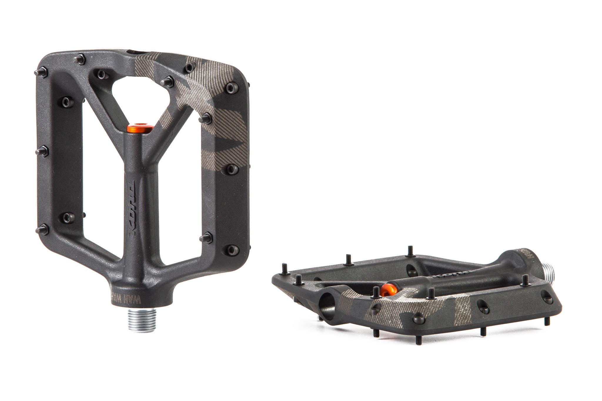 Side angle of durable flat pedals on mountain bike in rough terrain