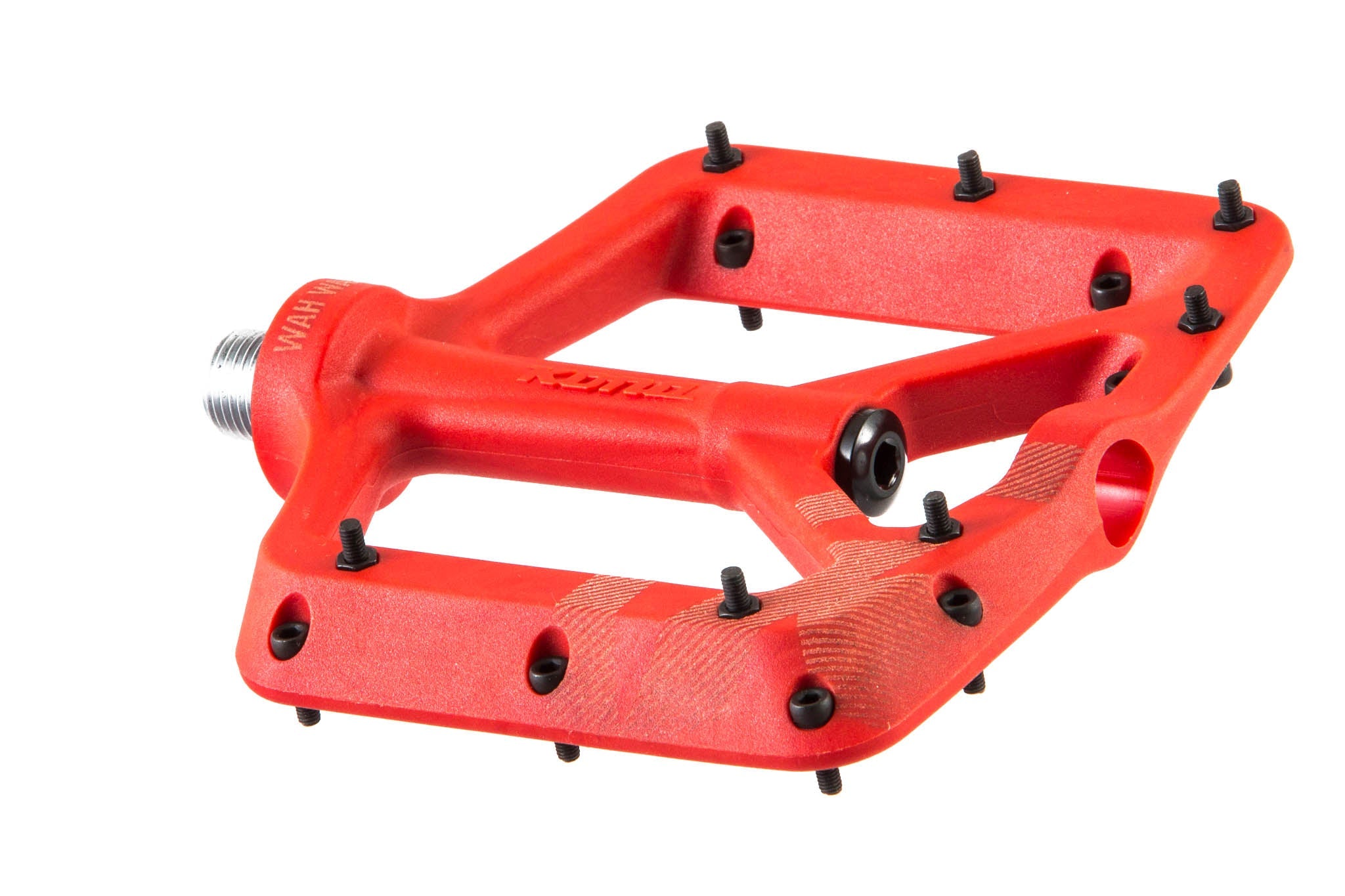 Side angle of durable flat pedals on mountain bike in rough terrain