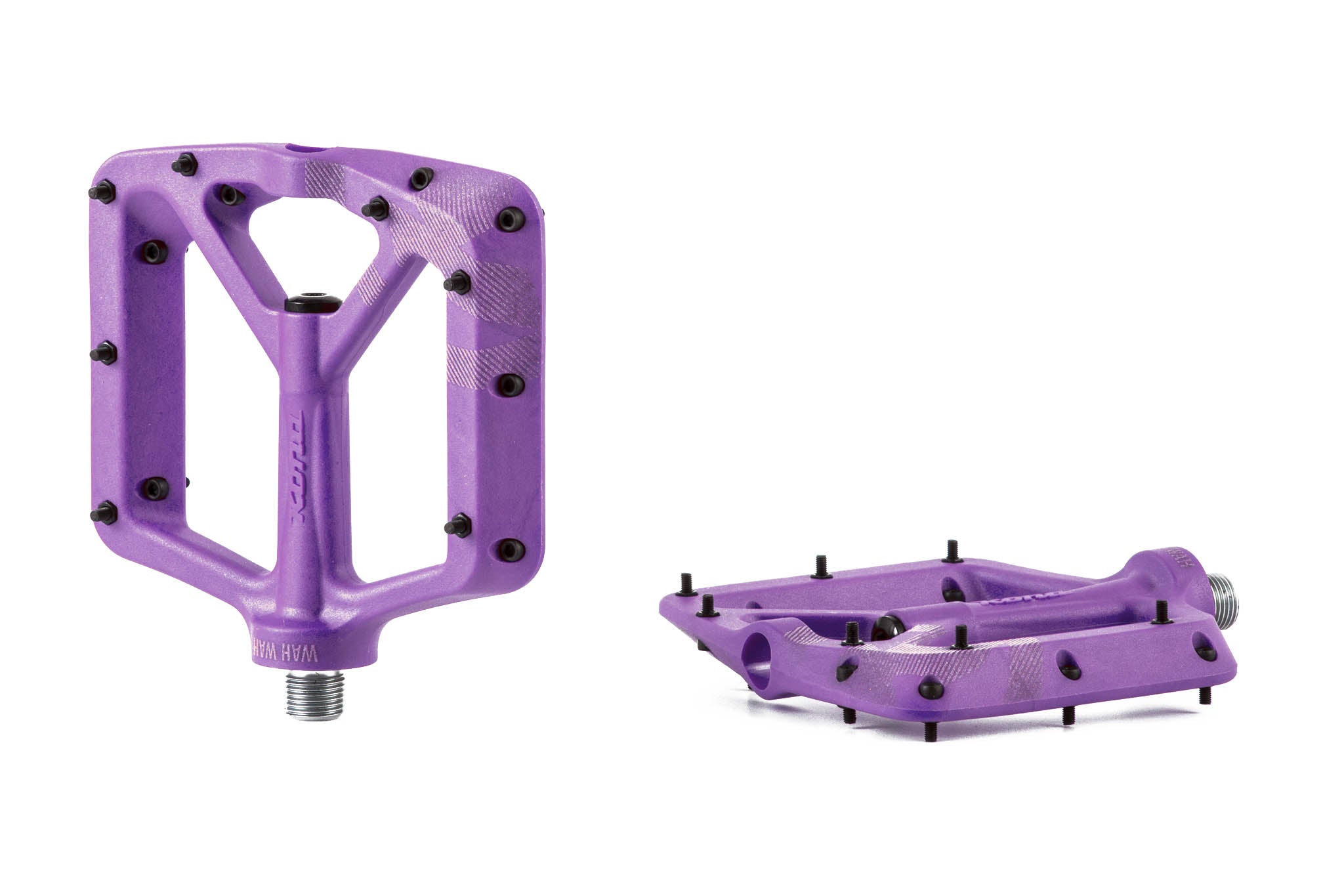 Side angle of durable flat pedals on mountain bike in rough terrain