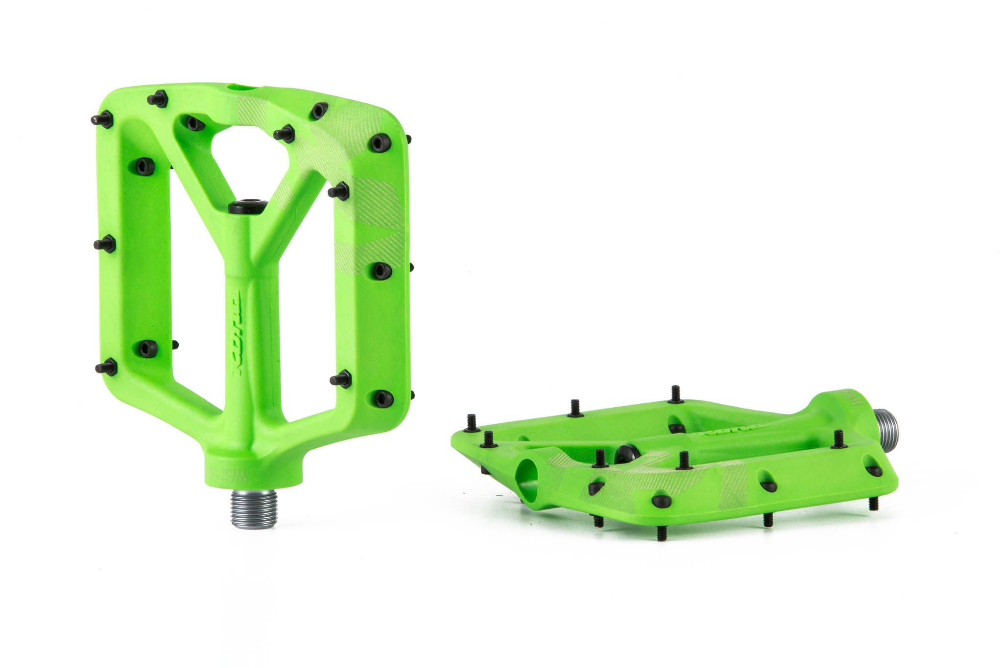 Side angle of durable flat pedals on mountain bike in rough terrain