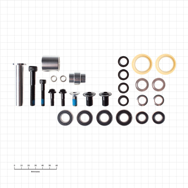 Side-angle shot of the Tanuki TrailMaster™ back-country bushing kit laid out on a workbench, showing numbered bushings and stainless bolt kit arranged by size