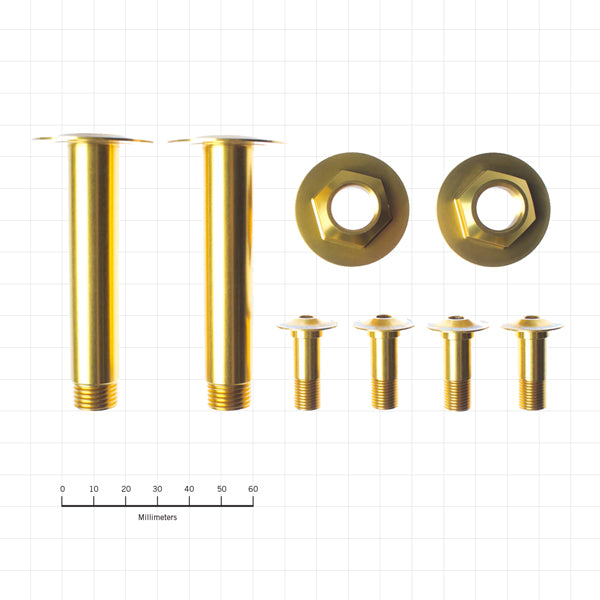 Close-up of gold bolt kit laid on workbench showing anodized finish and precision threads