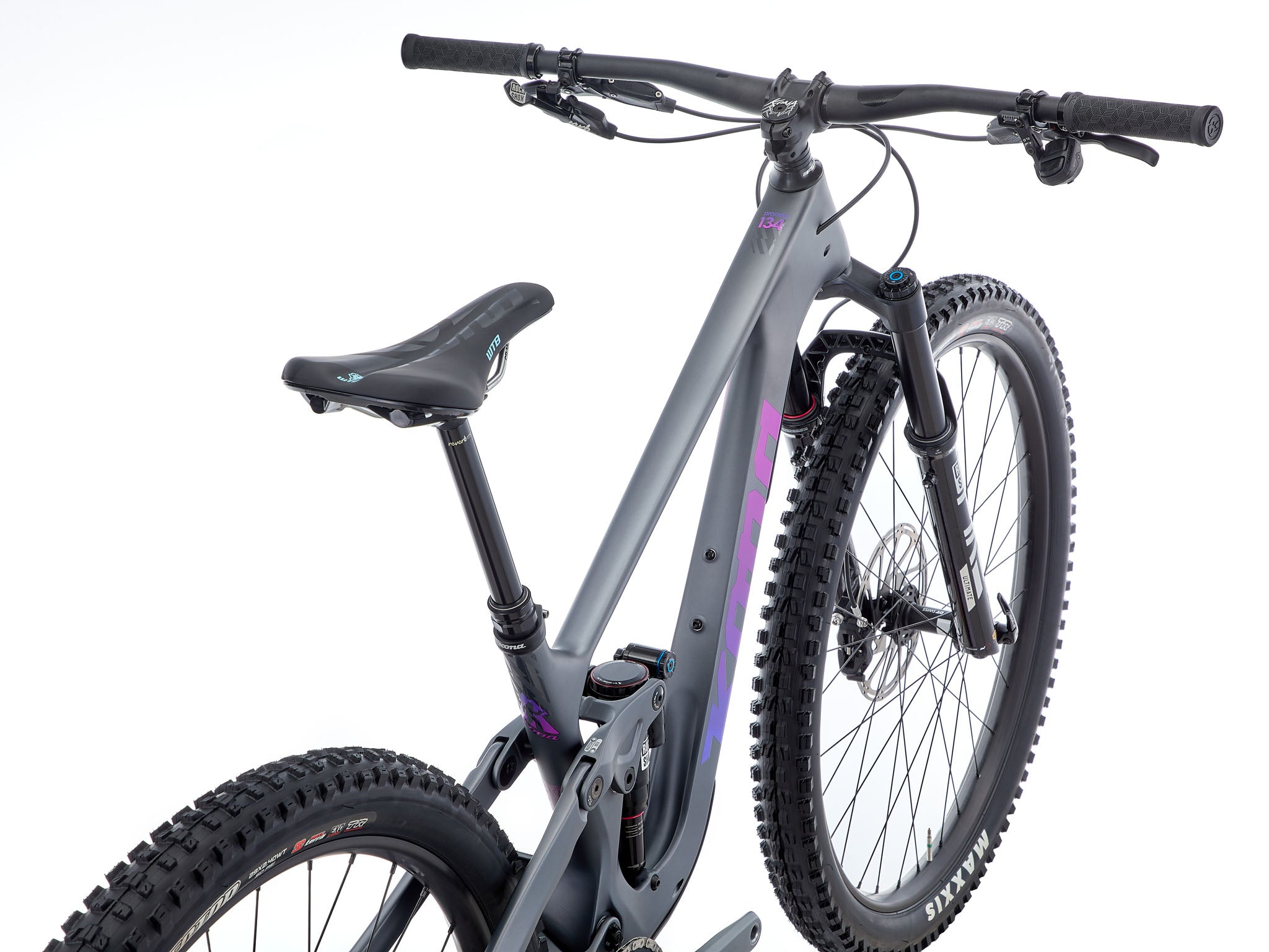 TrailMaster 134 Carbon Full Suspension Bike in action on a rugged trail.