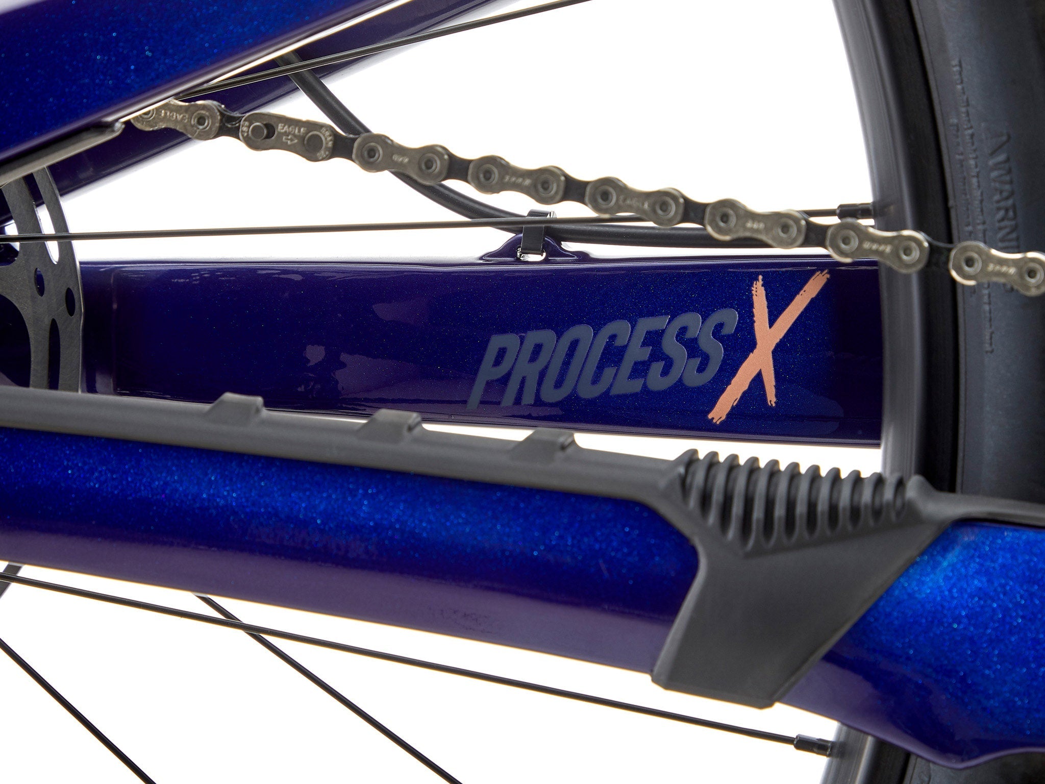 Rider navigating technical terrain on the Kona Process X CR DL full suspension bike.