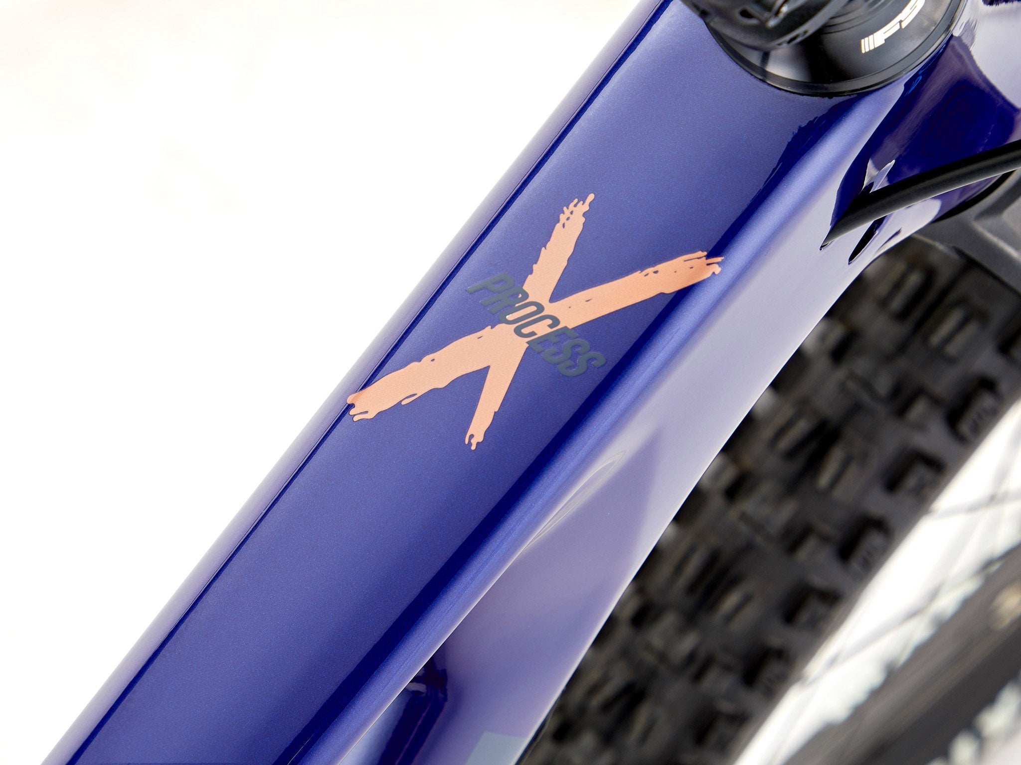 Rider navigating technical terrain on the Kona Process X CR DL full suspension bike.